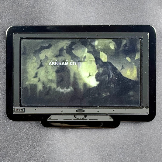 Vintage television set displaying a video game screen with 'Arkham City' text on a gray background