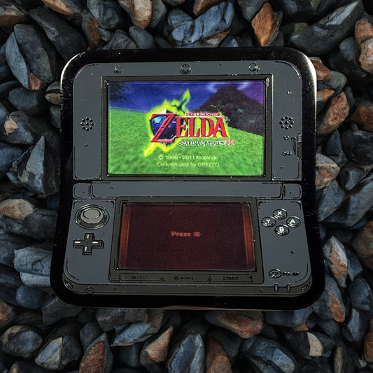 Handheld gaming console displaying 'The Legend of Zelda' game on a stone surface