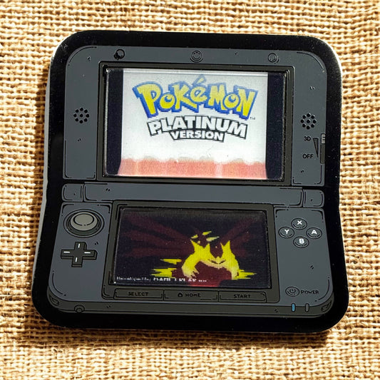 Nintendo DS with 'Pokémon Platinum Version' on screen, displayed on a textured fabric background