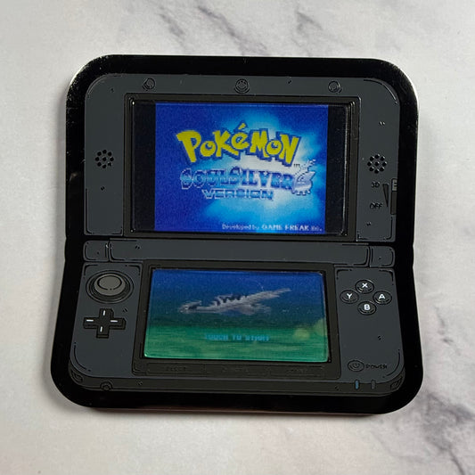 Black Nintendo DS with 'Pokémon Gold – Silver Version' displayed on screens.