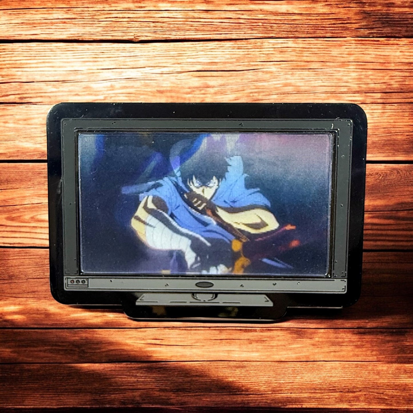 Small screen displaying an animated character on a wooden surface