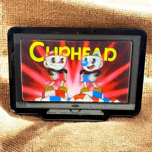 Game cartridge with 'Cuphead' branding on a textured surface