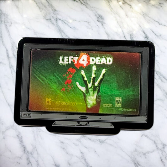 Game console with 'Left 4 Dead' game displayed on a marble surface