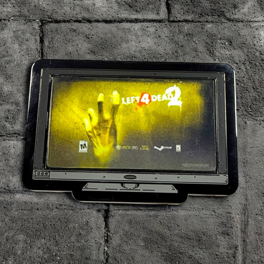 Vintage television set displaying 'Left 4 Dead 2' game on a brick wall.
