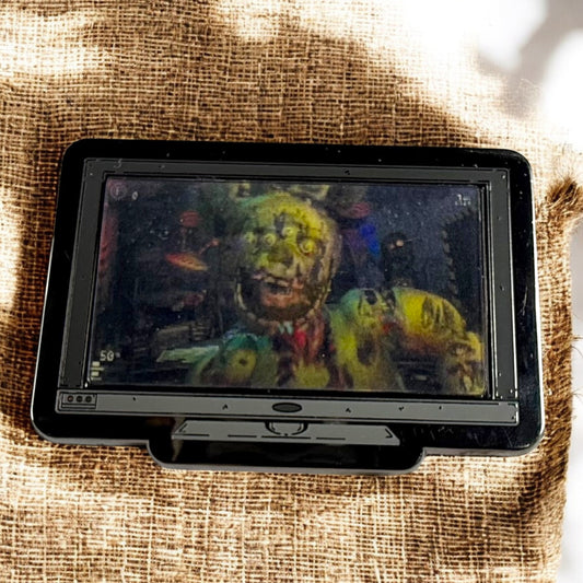 Vintage television set displaying a colorful zombie graphic on a textured fabric background