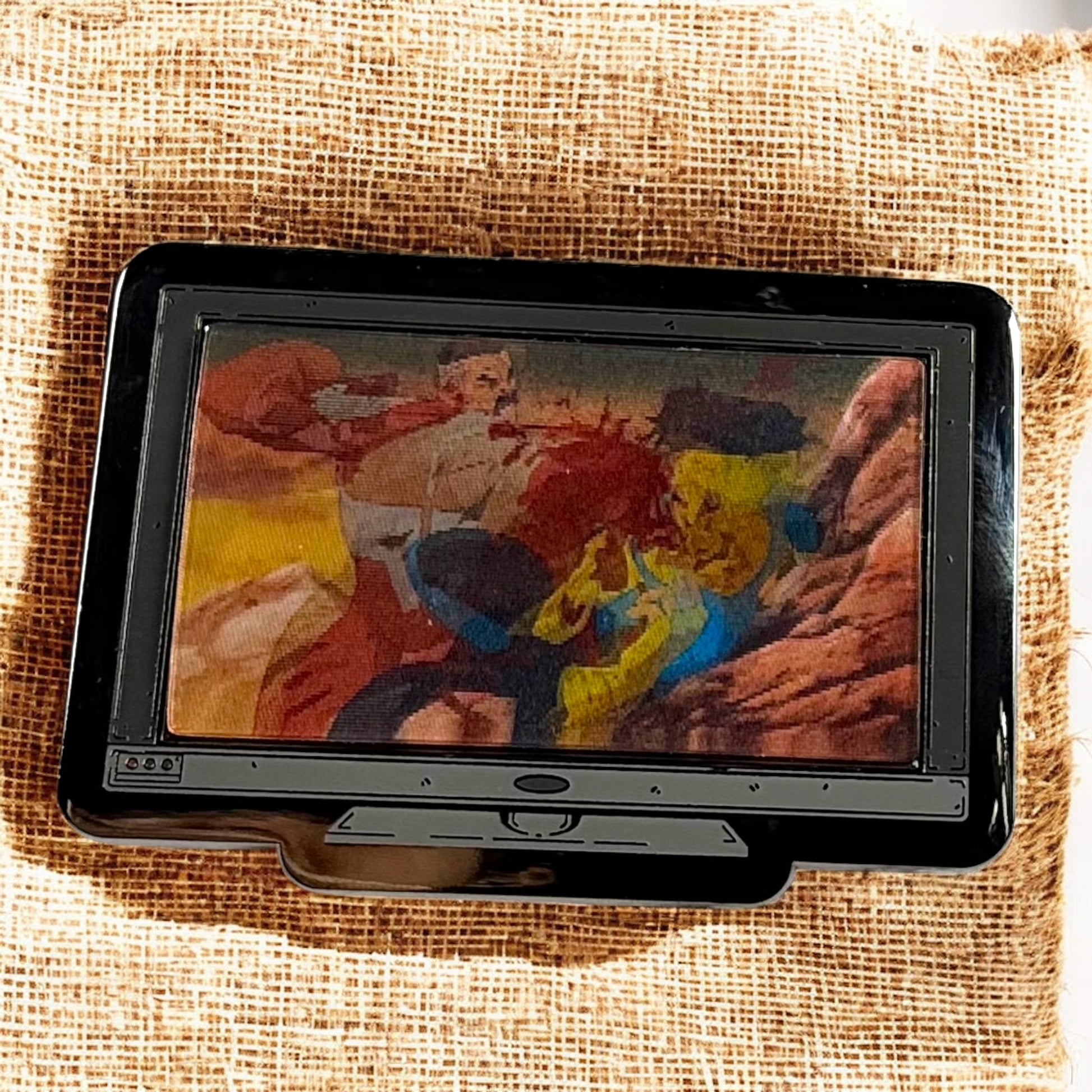 Digital photo frame displaying a colorful image on a textured fabric background