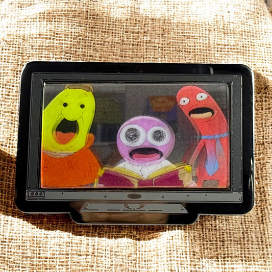 Small screen displaying colorful cartoon characters on a textured fabric background