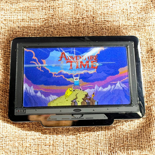 Small screen displaying 'Adventure Time' on a textured fabric background