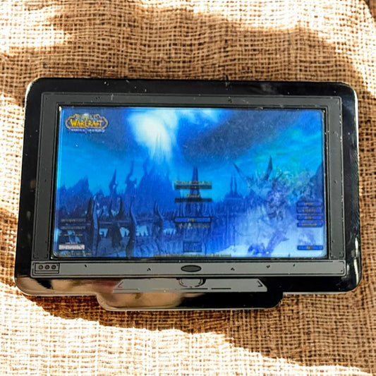 Portable DVD player displaying a fantasy scene on a textured surface