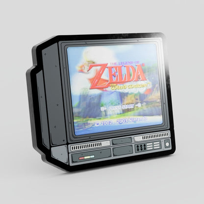 Vintage-style gaming console with 'The Legend of Zelda' game displayed on screen Zelda Lenticular Enamel Pin